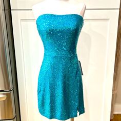 Nwt B. Darlin Blue Sequined Sweetheart Neckline Strapless Stretch Dress, Back Zip, Rubberized Strip Along Top Perimeter To Help Keep Top In Place, Flat Laid Measurements: Pit To Pit 16”, Waist 15”, Hips 18”, There Is Approximately 3” More For Stretch Allowance Glamorous Blue Mini Dress With Fitted Bodice, Blue Sequined Strapless Dress, Blue Strapless Fitted Dress With Sequins, Fitted Blue Strapless Dress With Sequins, Blue Strapless Sequin Dress, Blue Strapless Dress With Sequins For Evening, Glamorous Blue Dress With Sweetheart Neckline, Glamorous Blue Strapless Dress For Prom, Blue Mini Dress With Straight Neckline For Party