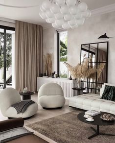 a living room filled with white furniture and lots of window sill space next to a large mirror