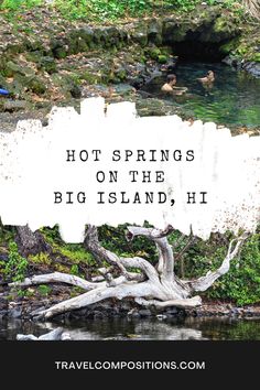 a sign that says hot springs on the big island, hi in front of some water