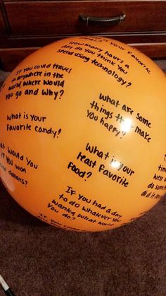 an orange balloon with words written on it