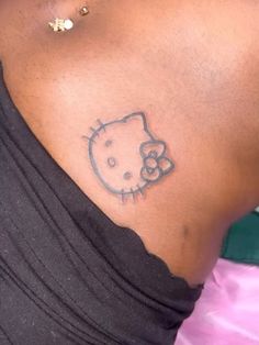 a woman with a hello kitty tattoo on her back