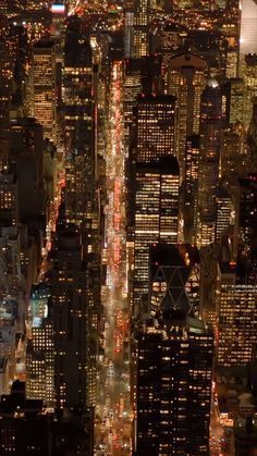 an aerial view of new york city at night from the top of the empire building