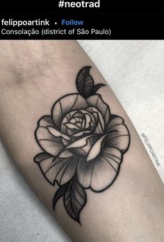 a black and white rose tattoo on the arm