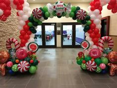 an entrance decorated with balloons and candy canes