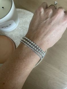 "- Sterling Silver Hand Beaded Bracelets - .925 Sterling Silver - Bead sizes: Small (3mm), Medium (4mm), and Large (5mm)  - Perfect accessory to your apple watch and layering with other jewelry, made to STACK! - Elastic band - Custom wrist sizing available - standard wrist size is 7inches - For best fit, measure your wrist at the wrist bone with a measuring tape or string. Add 1/2\" to that measurement for a snug fit, 3/4\" - 1\" for a comfort fit, or 1\" or larger for a loose fit. * If you do not see the wrist size you are looking for please let me know in the comments the size you would like in 'inches' - Handmade to order and can also be customized with lettered beads offered in: Black with white lettering, White with black lettering and White with Rainbow letters  * Please add your cus Everyday Silver Bracelets With Tiny Beads, Sterling Silver Bracelets With Tiny Beads For Everyday, Everyday Sterling Silver Bracelets With Tiny Beads, Sterling Silver Bracelets With Round Beads, Silver Bracelet With Tiny Beads, Silver Stackable Beaded Bracelets For Everyday, Sterling Silver Beaded Bracelets For Everyday, Sterling Silver Bracelet With Round Beads For Everyday, Everyday Sterling Silver Beaded Bracelet