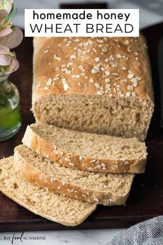 a loaf of homemade honey wheat bread on a cutting board