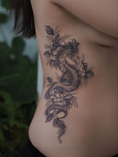 a woman with a dragon tattoo on her stomach is shown from the waist down,