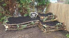 a pile of dirt sitting next to a wooden fence