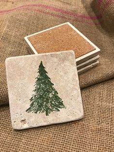 three coasters with green pine tree on them