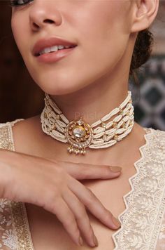 A work of art in jewelry, our Indian Bridal Kundan Choker Necklace captures the essence of celestial beauty and feminine grace. The centerpiece showcases a crescent moon motif, encrusted with Kundan, reflecting the radiance of the night sky strewn in luminous pearls. Every detail in this traditional pearl choker is inspired by the Sabyasachi Jewelry. From the delicate placement of pearls to the celestial motif,  the gold-plated necklace embodies a sense of celestial enchantment, inviting you to embrace the timeless beauty of the moon. Necklace- Adjustable Dori Weight- 57 gm Paisley Pop travels the depths of India to learn techniques and crafts from deep down in the local markets and villages. We give utmost importance to our quality and packaging. Our goal is to make sure you receive exact Intricate Design Choker Necklace For Diwali, Diwali Choker Necklace With Intricate Design, Intricate Choker Necklace For Diwali, Elegant Jewelry With Tilla For Rituals, Handmade White Fusion Jewelry, Gold Cutdana Fusion Necklace, Choker Jewelry With Tilla For Rituals, Ceremonial Meenakari Choker Necklace, Gold Fusion Style Bridal Necklace With Cutdana