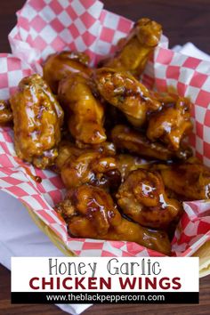 honey garlic chicken wings in red and white checkered paper with text overlay that reads honey garlic chicken wings