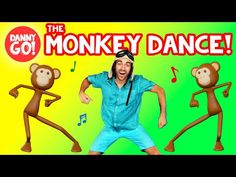 a man in blue shirt and shorts dancing with monkeys