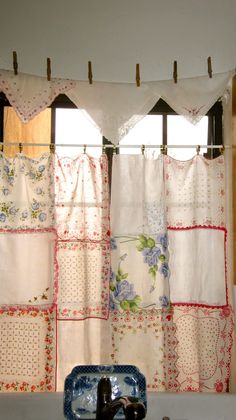 a kitchen with a sink, window and dishwasher in front of the curtain