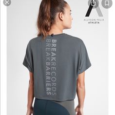 Athleta Nwt Legend Short Sleeve Short Tee “Break Record Barriers” Color: Bali Green Brand New With Tag $54.00 Size: 2x Oversized Fit, Super Soft On Body, Special Allyson Felix Graphic, Anti-Oder Technology, Moisture Wicking, Fair Trade Certified. Underarm To Underarm: 31", Back Of Neck To Hem: 23" 75% Polyester, 19% Lyocell, 7% Spandex, Super Soft!! Color: Bali Green Smoke And Pet Free Home Sporty Athletic Fit T-shirt For Light Exercise, Gray Athleisure T-shirt For Running, Sporty Gray T-shirt For Running, Athletic Heather Workout Tops With Short Sleeves, Gray Athleisure T-shirt For Training, Gray Relaxed Fit Activewear For Sports, Gray Athletic Fit Crew Neck Activewear, Athletic Heather Stretch Top With Go-dry, Breathable Stretch Athletic Heather Tops