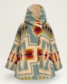 An exquisite statement piece, designed by Lindsey Thornburg and crafted from one of Pendleton's wool jacquard blankets, woven in our Pendleton, Oregon mill. Each cloak is hand-cut, then sewn and finished in Lindsey’s Manhattan studio. The bell-shaped silhouette features horn toggle closures, oversized raglan sleeves, a large cocoon hood, two welted patch pockets and a swingy fit for easy layering. Each cloak weighs 6 lbs. and is appropriate for mountain winters. This design, features Pendleton's Lindsey Thornburg, Warren Harding, Pendleton Blankets, Pendleton Blanket, Blanket Coat, Oregon Trail, Sweat Dress, Hooded Cloak, Pendleton Wool