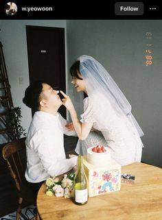 a bride and groom feeding each other cake