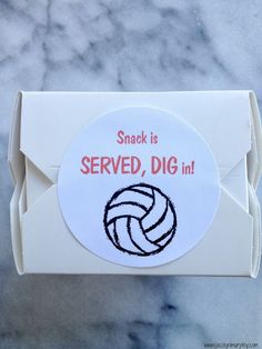 a white envelope with a sticker on it that says snack is served dig in