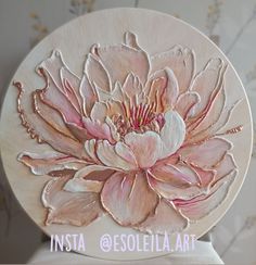 a close up of a flower on a white plate with words insta esolecia art