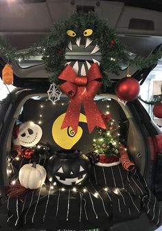 the trunk of a car decorated for halloween with decorations, lights and ornaments on it