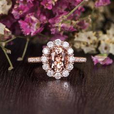 a ring with an oval cut diamond surrounded by flowers