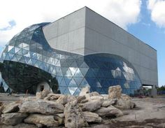 a large building that has some rocks in front of it