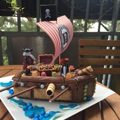 a pirate ship cake is sitting on a table