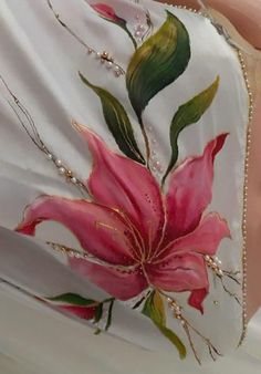 a white dress with pink flowers painted on it