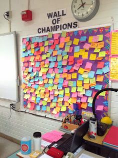 a bulletin board with post it notes on it and a clock mounted to the wall