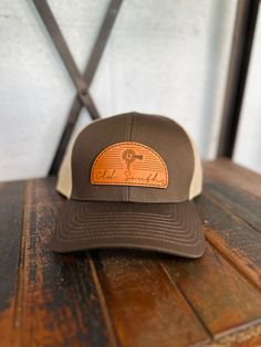 Arch Leather Patch - Trucker Hat - Brown/Khaki Keeping the hot southern sun out of your eyes and away from your face is important during the heat of June, July and August--both for guys and gals. Our classic, wide-brimmed trucker hat subtly announces your southern roots while shading your head and face. Crown: Structured Pro Crown | Pro-Stitched Finish | Adjustable Snap-BackVisor: Pre-Curved | Curved or Flat - Shape It How You WantSweatband: 3-Part Comfort Cotton FitClosure: Plastic Adjustable S Vintage Brown Trucker Hat For Outdoor, Brown Western Style Baseball Cap For Outdoor, Retro Brown Adjustable Snapback Hat, Retro Brown Snapback Hat For Outdoor, Casual Brown Trucker Hat For Travel, Country Style Brown Baseball Cap With Flat Brim, Brown Country Style Baseball Cap With Curved Brim, Brown Western Snapback Hat For Outdoor, Brown Flat Brim Country Baseball Cap