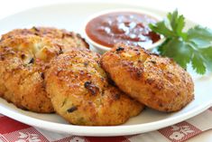 three crab cakes on a plate with dipping sauce