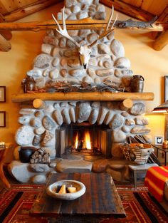 a living room with a fire place and stone fireplace