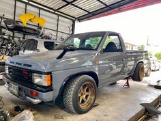 a truck is parked in a garage with other vehicles