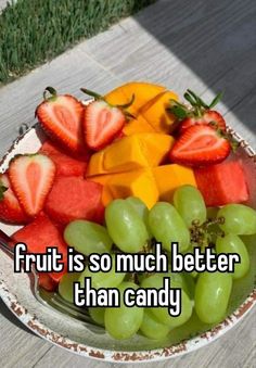 a bowl full of fruit with the words fruit is so much better than candy on it