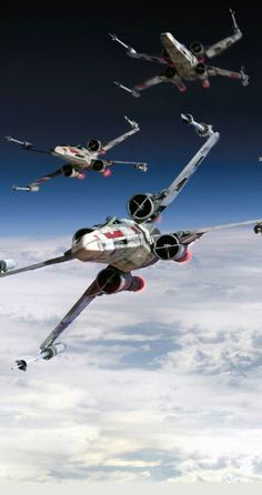 four star wars ships flying in the sky