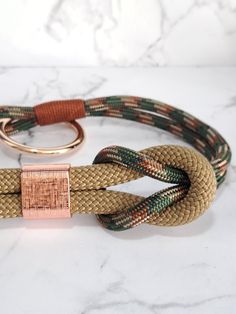 a close up of a dog leash on a marble surface with a metal ring attached to it