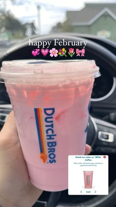 a person holding up a pink drink in their hand with the caption happy february