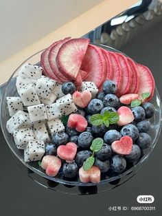 a glass bowl filled with fruit and veggies