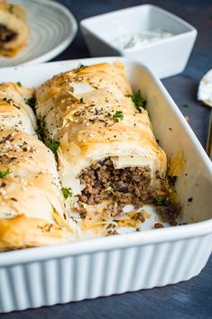 a casserole dish filled with meat and cheese