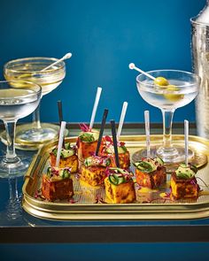 small appetizers on a tray with drinks