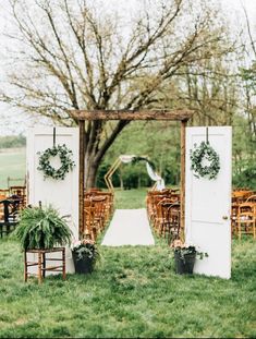 an outdoor ceremony setup with chairs and greenery