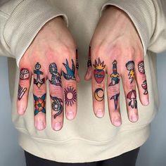 two hands with different tattoos on them, one has an arrow and the other has symbols