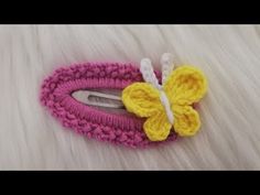 a crocheted hair clip with a yellow butterfly on it