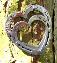 a heart shaped metal object attached to a tree