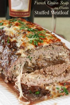 a meatloaf is cut into slices on a plate with wine in the background