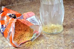 a bag of rice sitting next to a glass jar on a counter top with the lid open