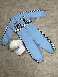 a baseball cap and overalls are laying on the floor next to a blue hat