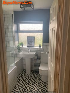 a bathroom with a sink, toilet and bathtub next to a window in it