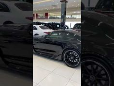 a black sports car is parked in a showroom