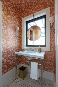 a bathroom with a sink, mirror and window in the wall next to it's tiled floor