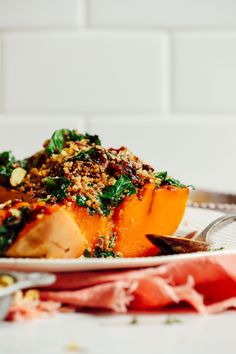 a close up of a plate of food on a table with utensils and napkins